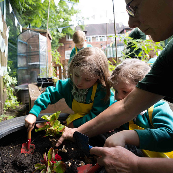 girls-digging-holes-for-plants